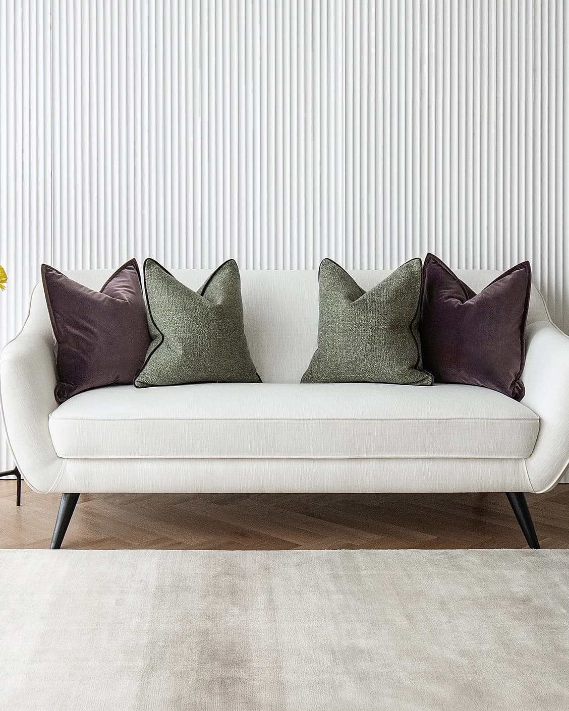 Kamelia Bundle cushion in purple and green, shown in a lifestyle front view as image 2