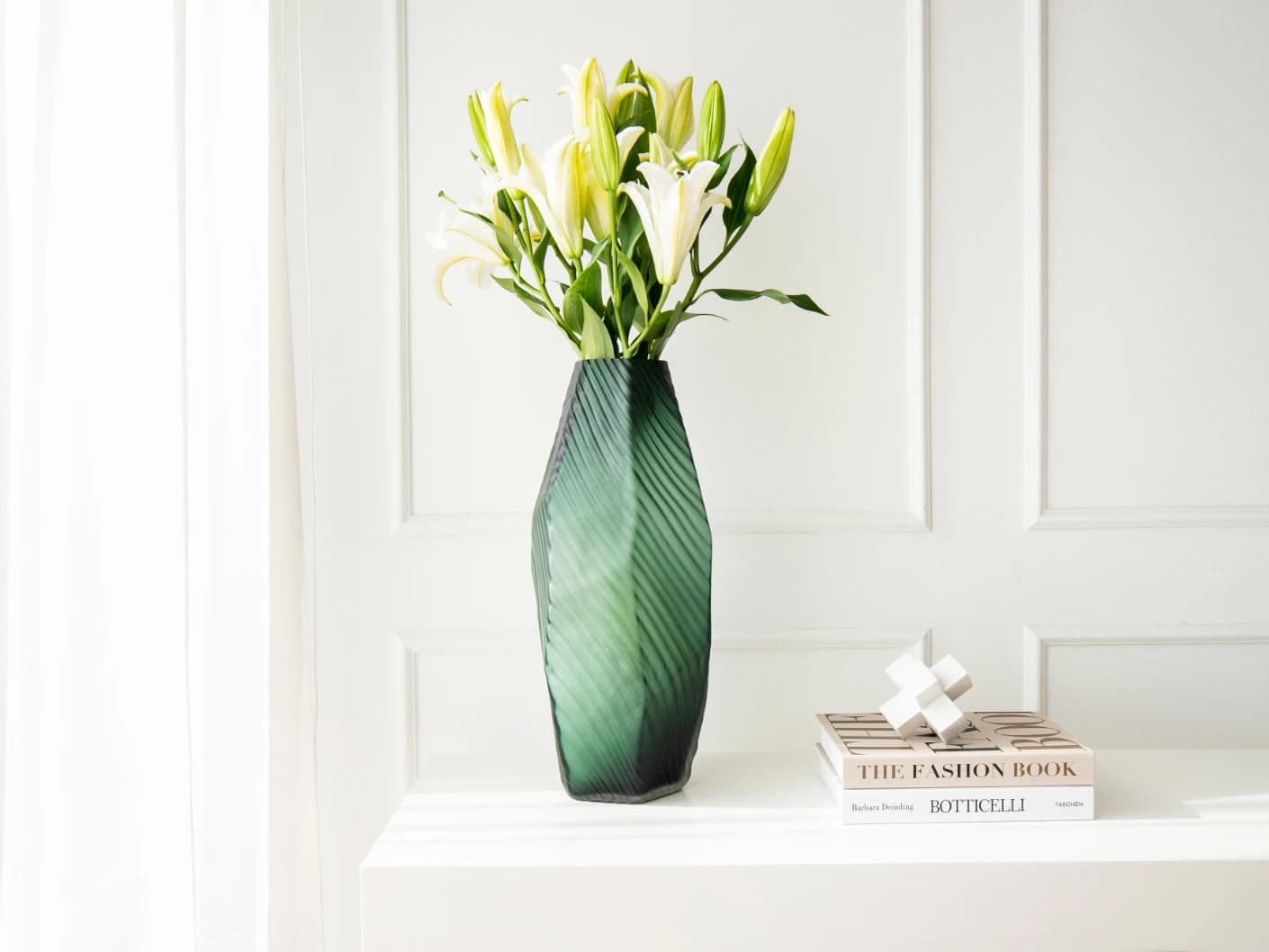 Keira Storms vases in green, shown in a lifestyle front view