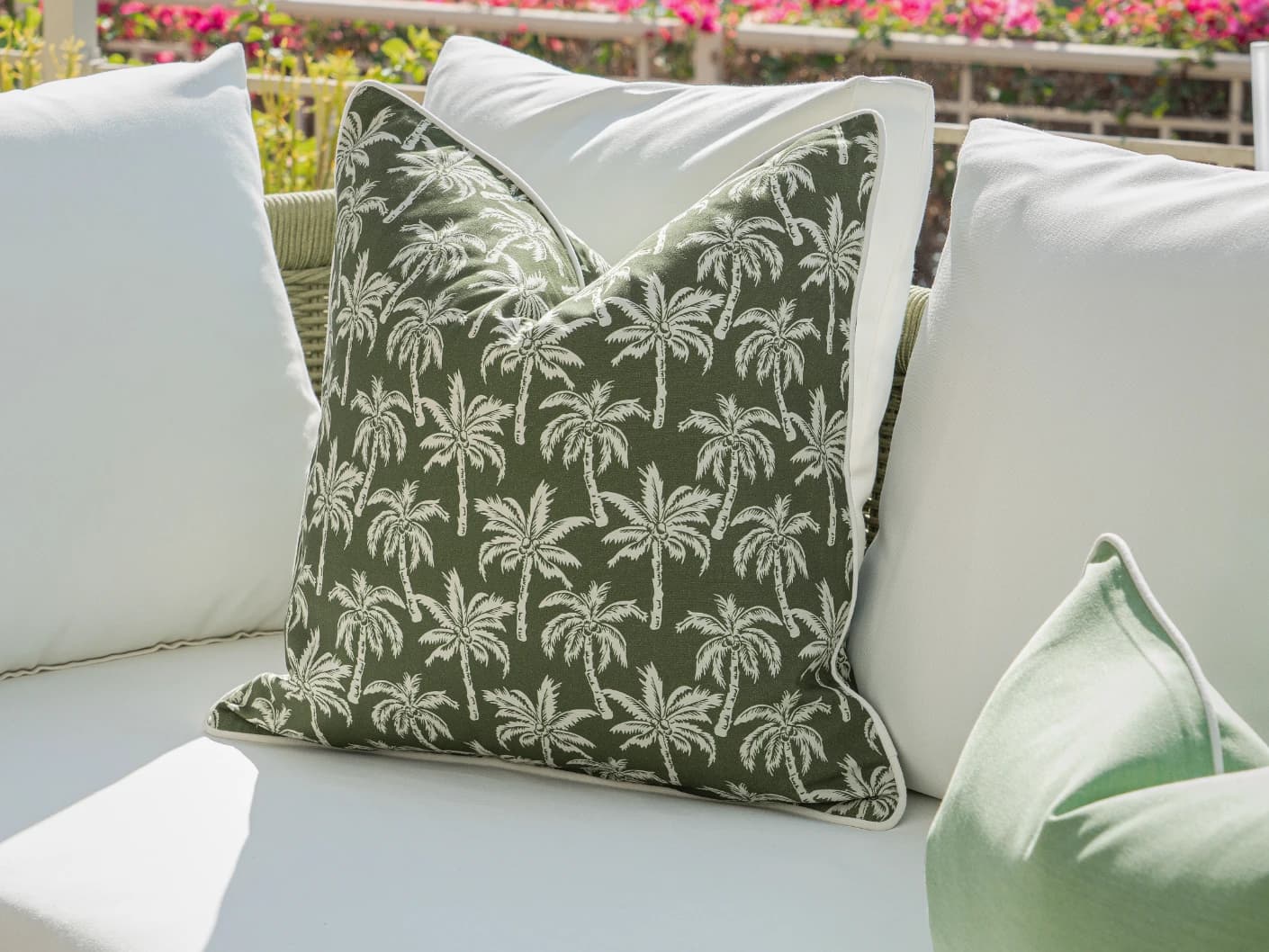 Keyla Bundle bundle cushions in green and ivory, shown in a lifestyle front view