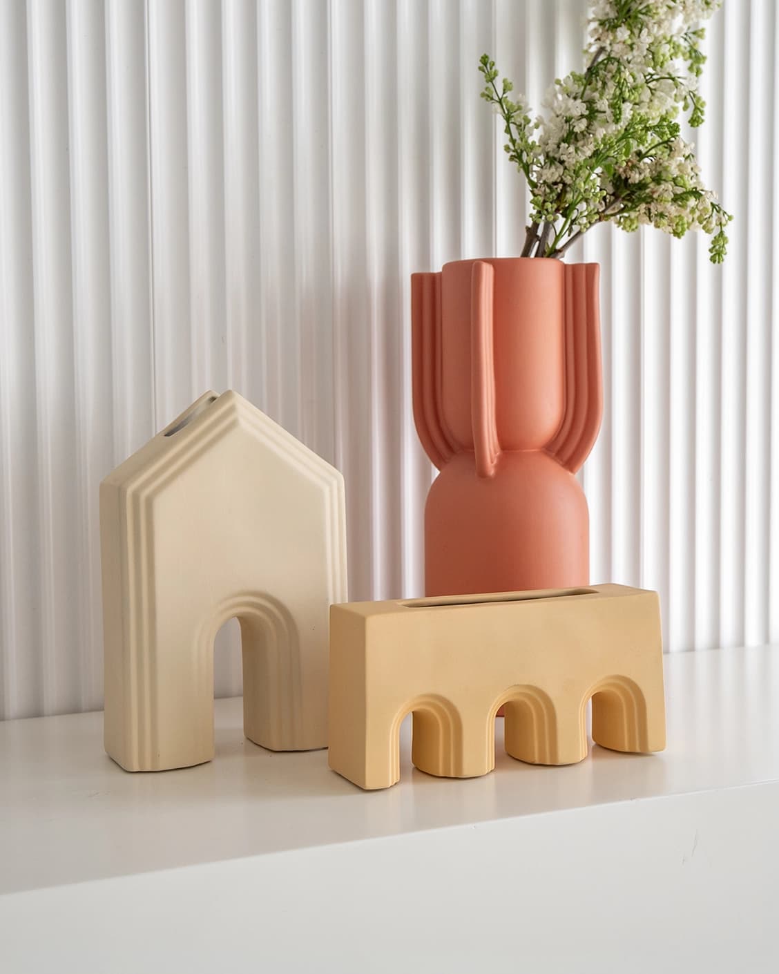 Klara Arneson vases in beige and orange, shown in a lifestyle front view as image 2