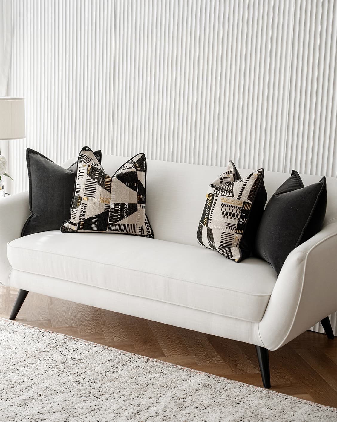 Krishna Bundle cushion in black, grey and beige, shown in a lifestyle right view as image 2