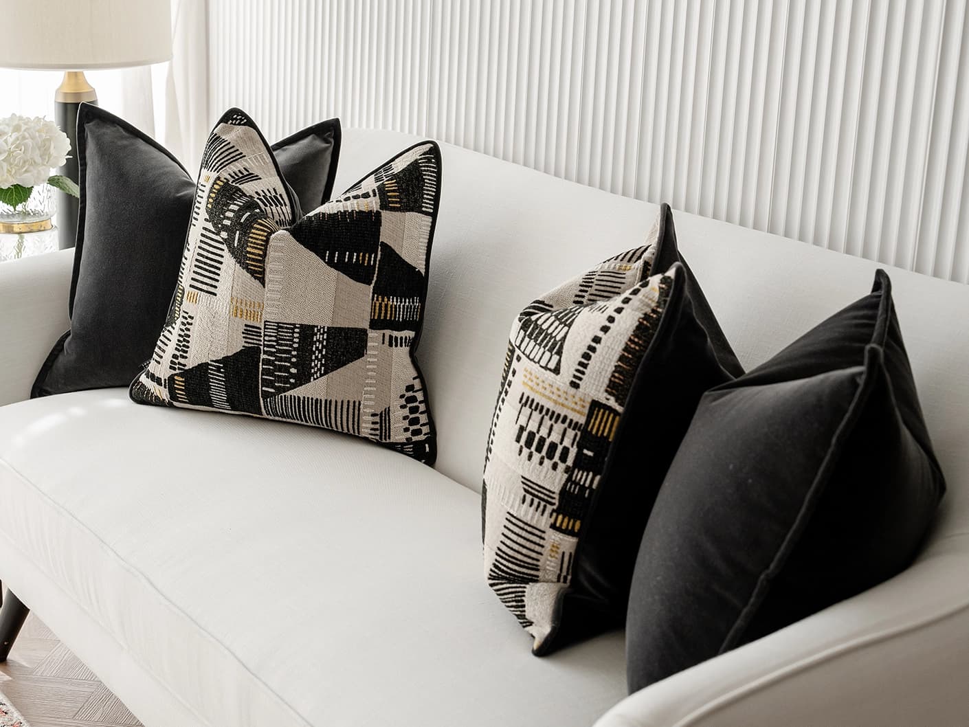 Krishna Bundle bundle cushions in black, grey and beige, shown in a lifestyle front view
