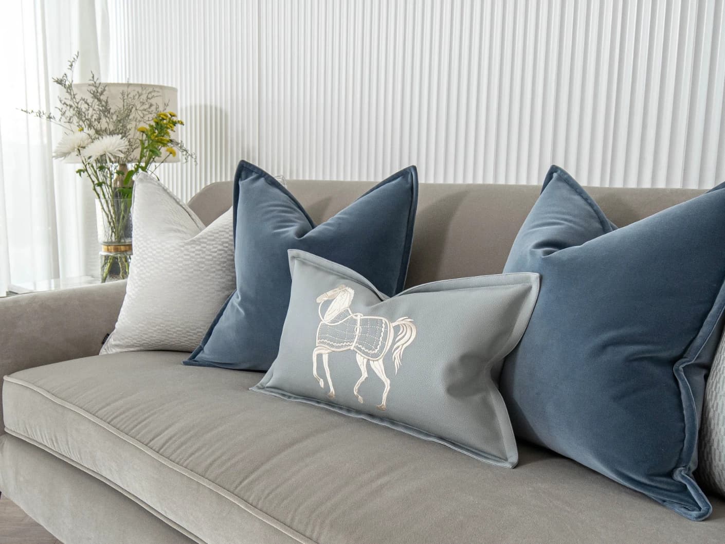 Kristal Bundle bundle cushions in blue, silver and white, shown in a lifestyle front view