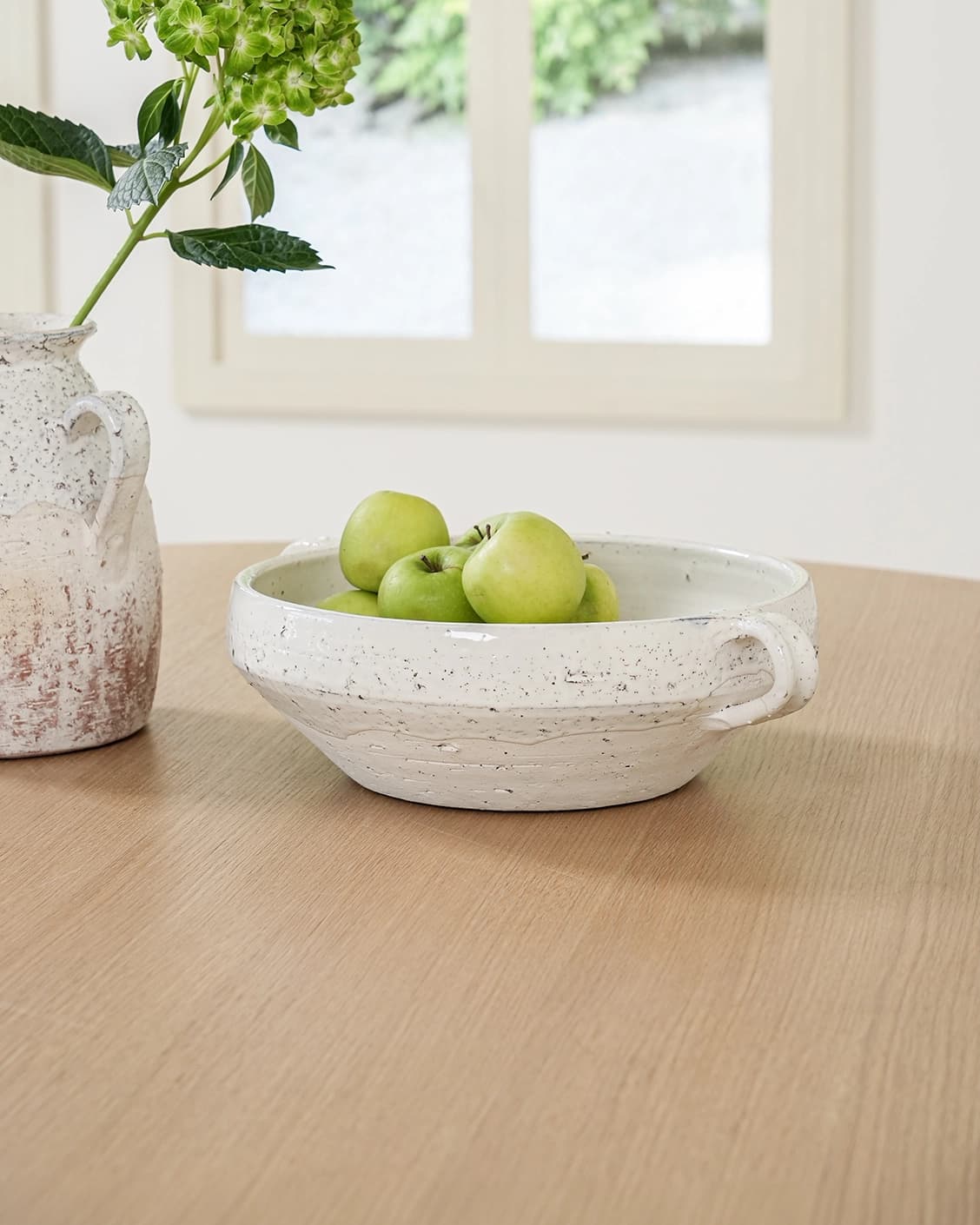 Kyan Terra bowls in soft stone and white, shown in a lifestyle front view
