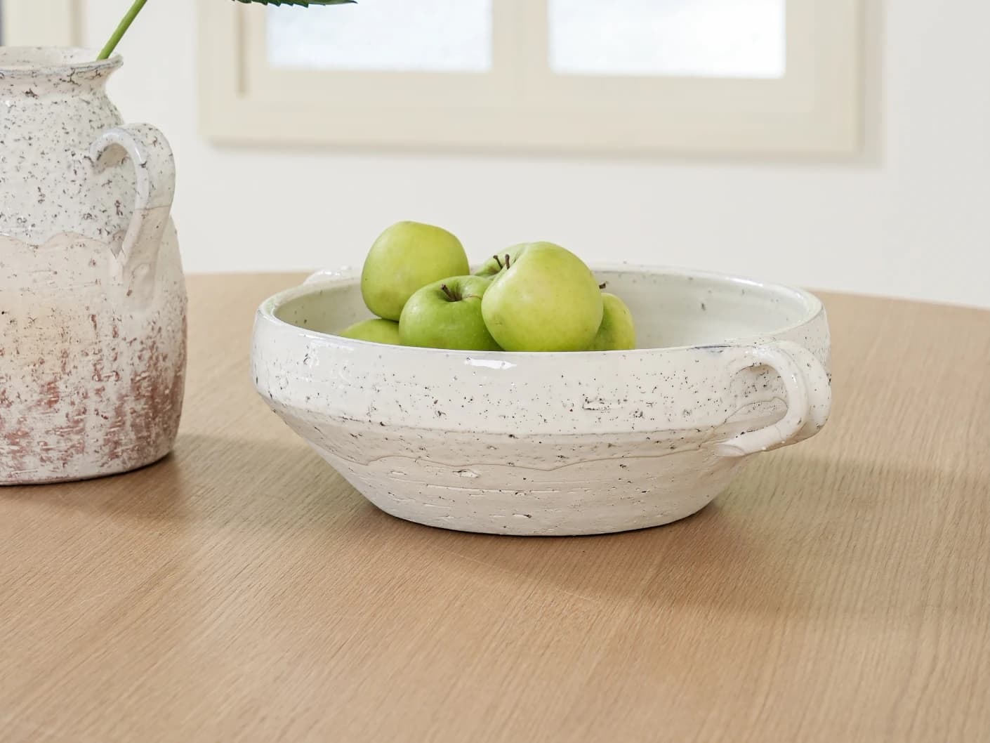 Kyan Terra bowls in soft stone and white, shown in a lifestyle front view