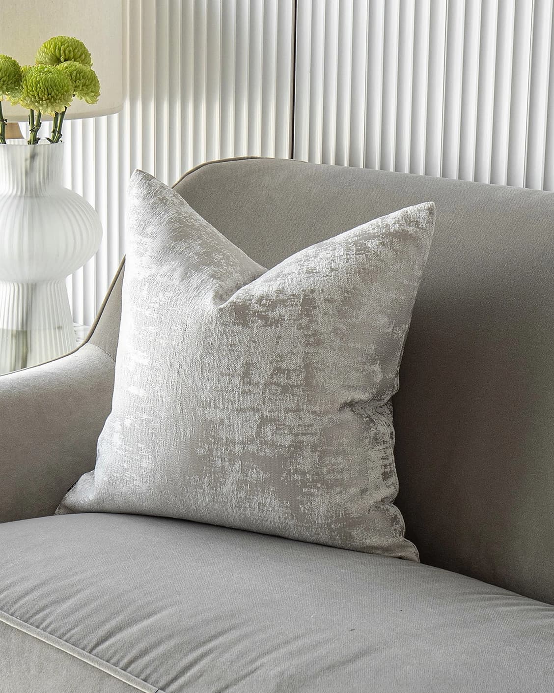Kylie Hodler cushion in silver and grey, shown in a lifestyle front view as image 2
