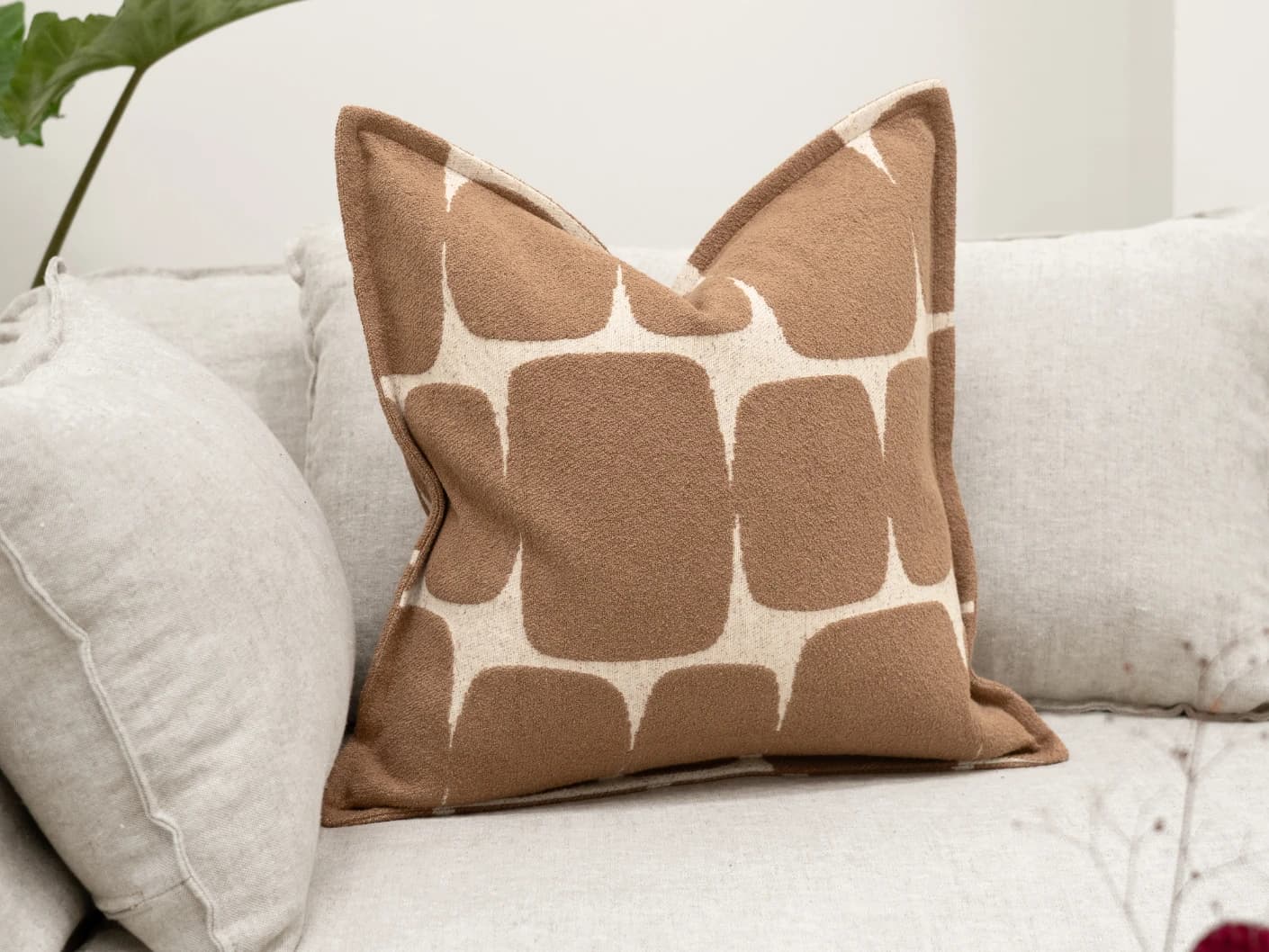 Kyomi Braun single cushions in brown, shown in a lifestyle front view