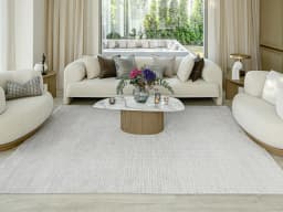 Laino Alba carpet in ivory and grey, shown in a lifestyle front view