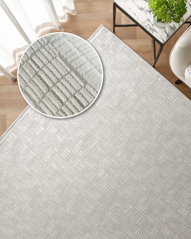 Laino Ashton carpet in ivory and grey, shown in a lifestyle top view as image 2