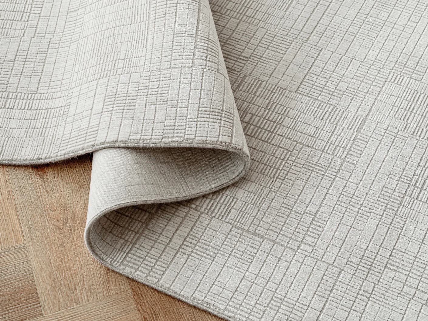 Laino Ashton carpets in ivory and grey, shown in a product close-up view