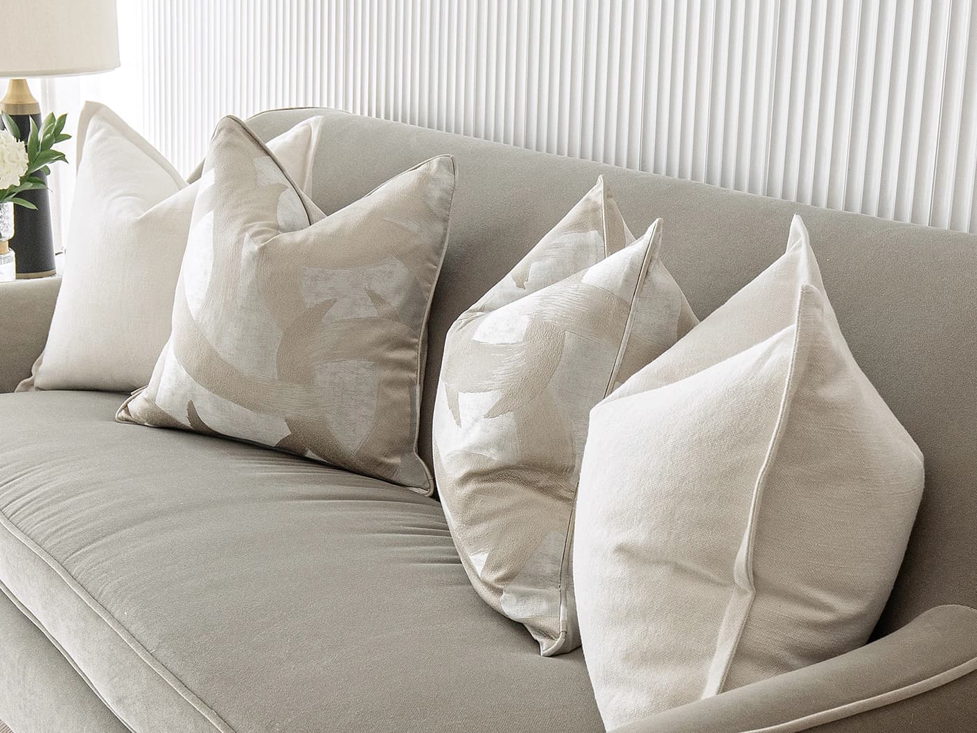Landers Bundle bundle cushions in white, silver and beige, shown in a lifestyle front view