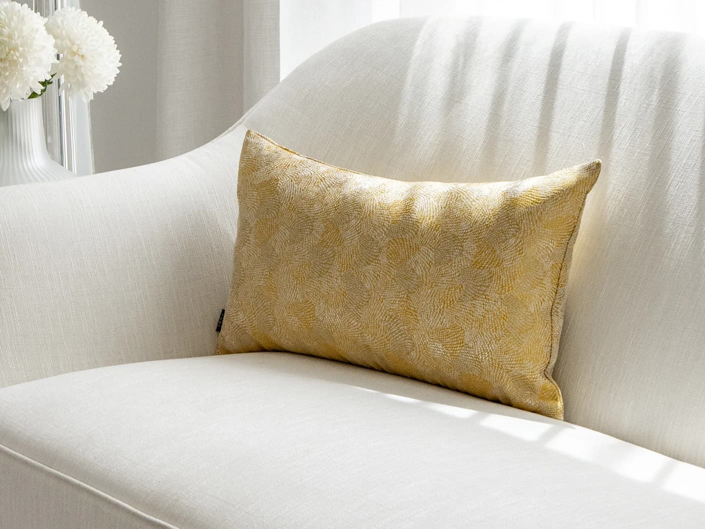 Leah Klimt single cushions in yellow, shown in a lifestyle front view