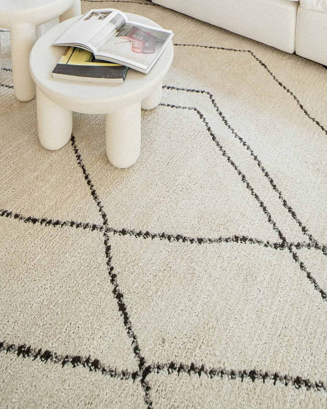 Leila Bianca carpet in beige and charcoal, shown in a lifestyle close-up as image 4