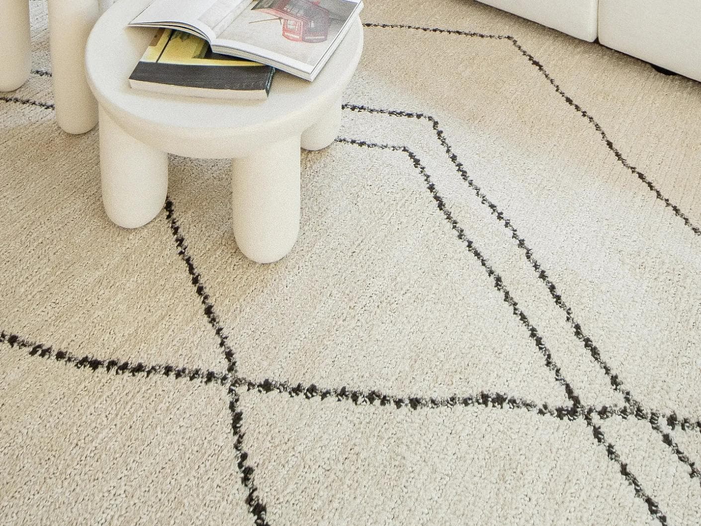 Leila Bianca carpet in beige and charcoal, shown in a lifestyle close-up as image 4