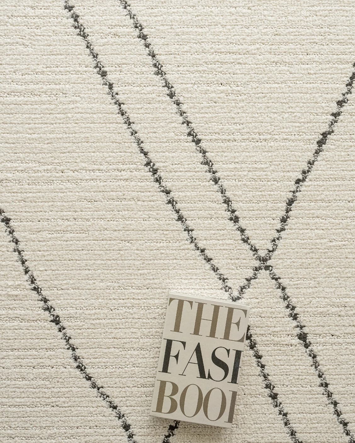 Leila Bianca carpet in beige and charcoal, shown in a lifestyle top view as image 11