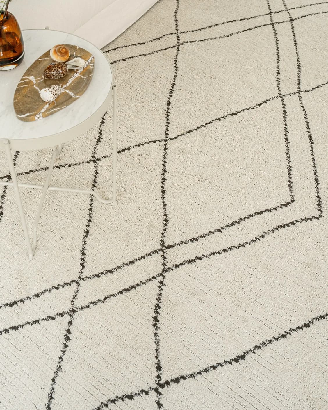 Leila Bianca carpet in beige and charcoal, shown in a lifestyle top view as image 13