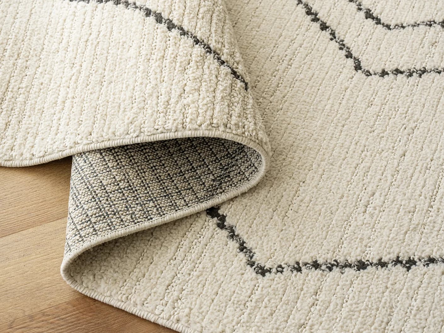 Leila Bianca carpets in beige and charcoal, shown in a product close-up view