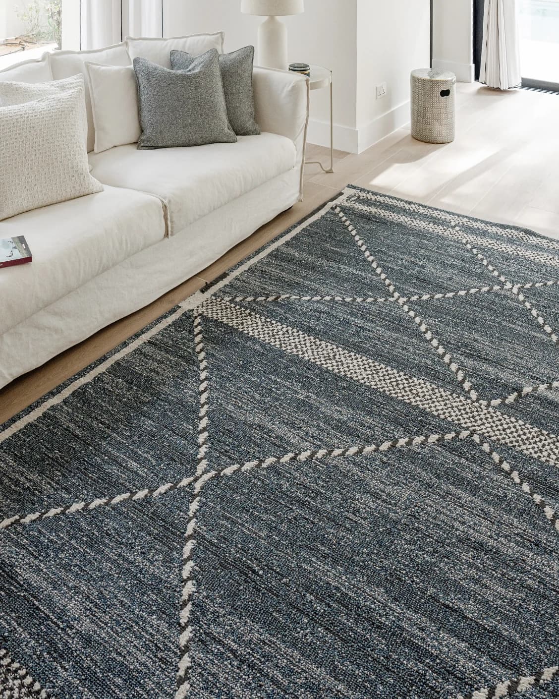 Leila Sky carpet in blue, shown in a lifestyle left view as image 8