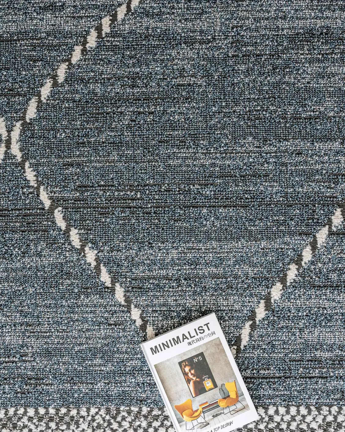Leila Sky carpet in blue, shown in a lifestyle top view as image 9