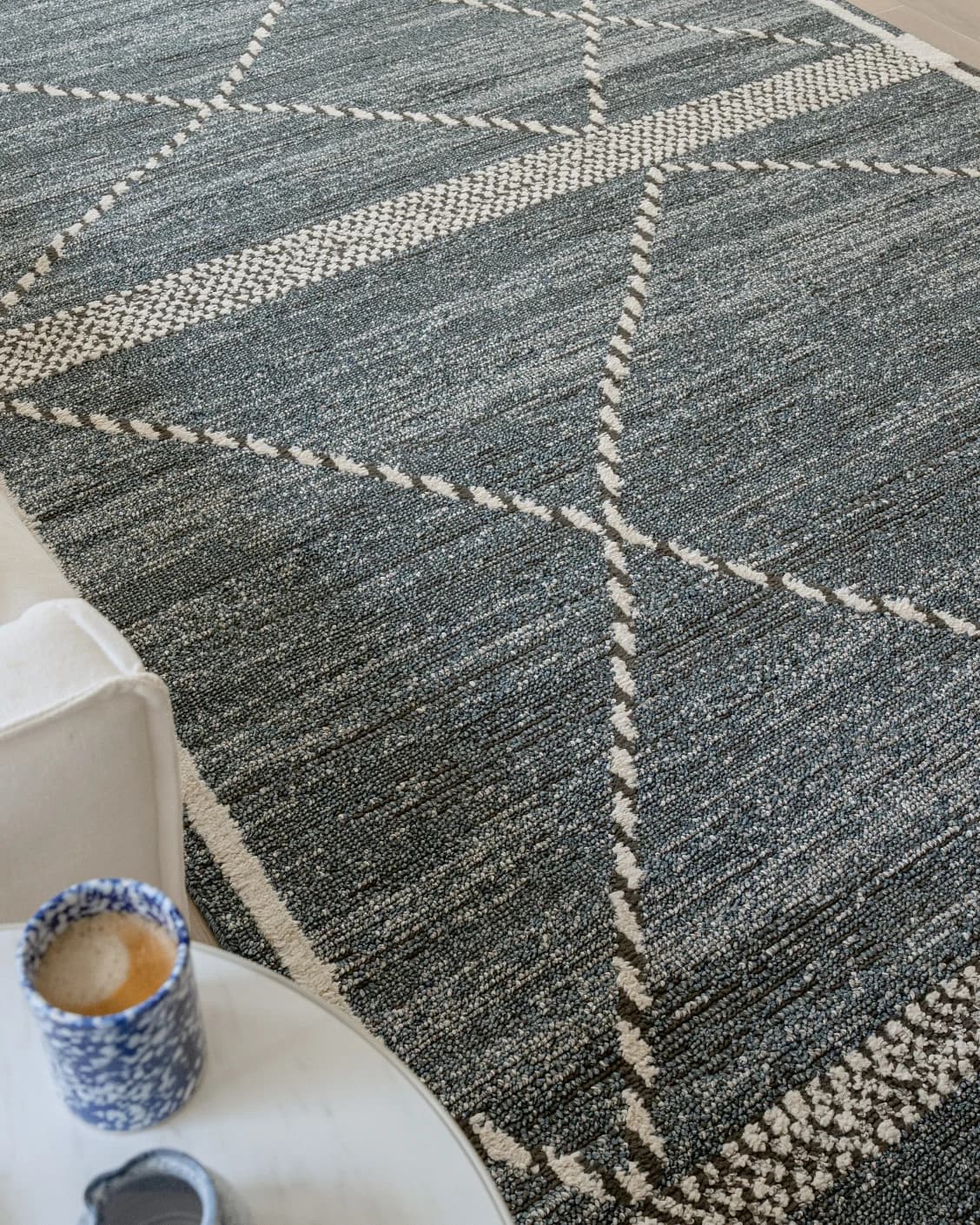 Leila Sky carpet in blue, shown in a lifestyle top view as image 10