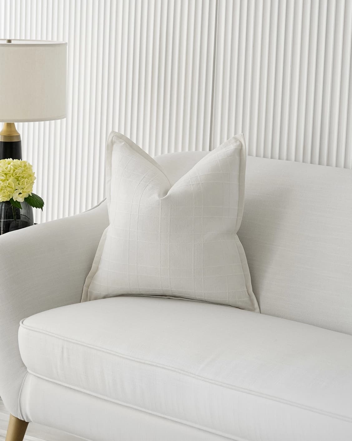 Lenora Bianca cushion in white, shown in a lifestyle front view as image 2