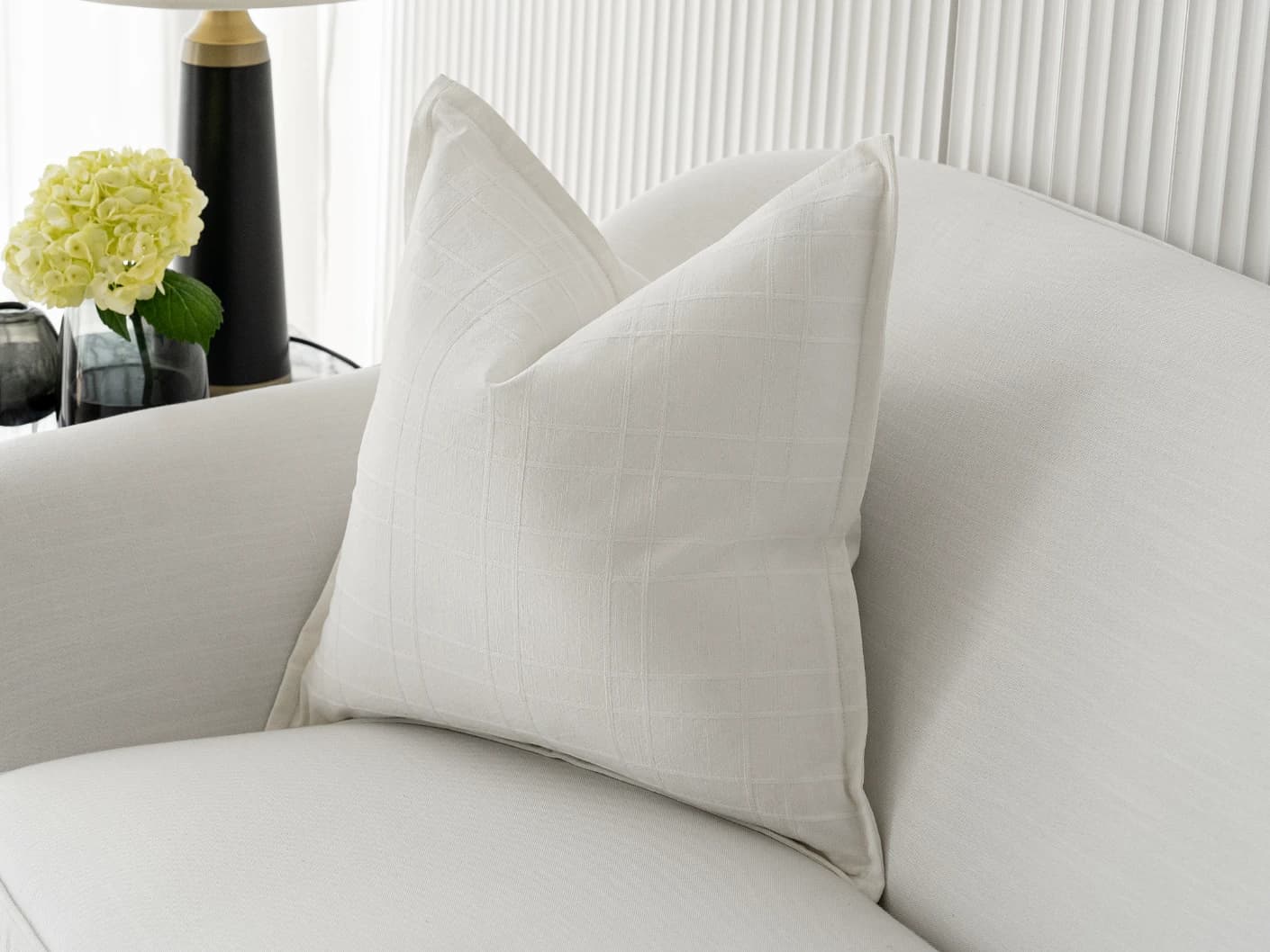 Lenora Bianca single cushions in white, shown in a lifestyle front view