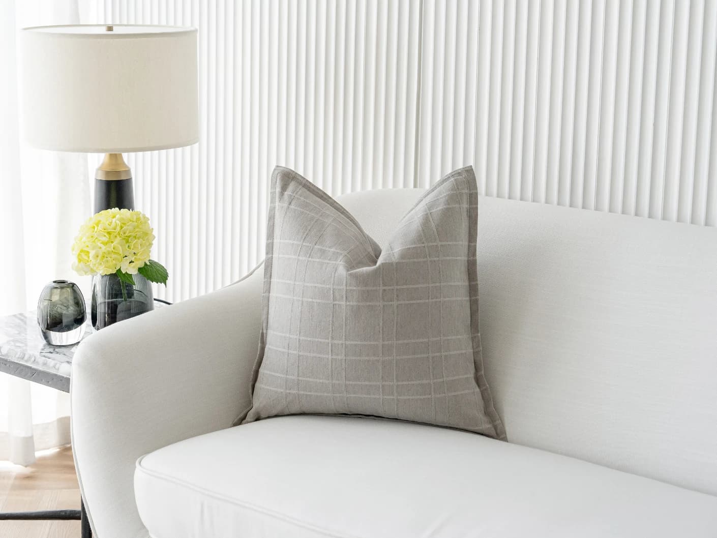 Lenora Laurent single cushions in grey, shown in a lifestyle front view