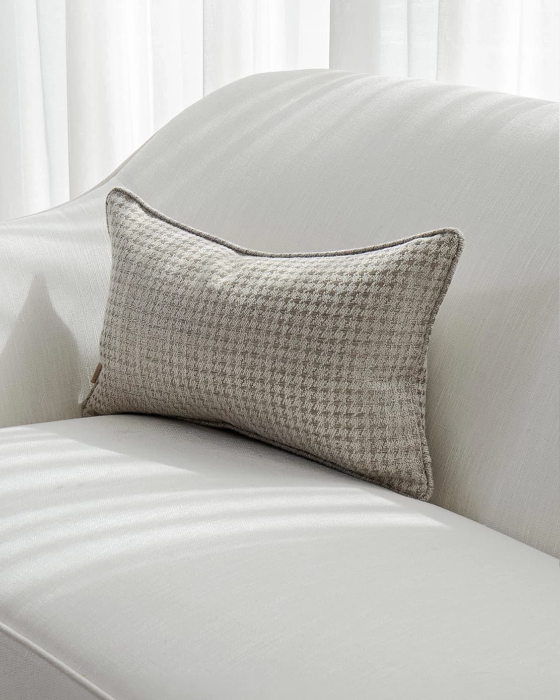 Leo Laurent II cushion in brown and silver, shown in a lifestyle front view as image 2