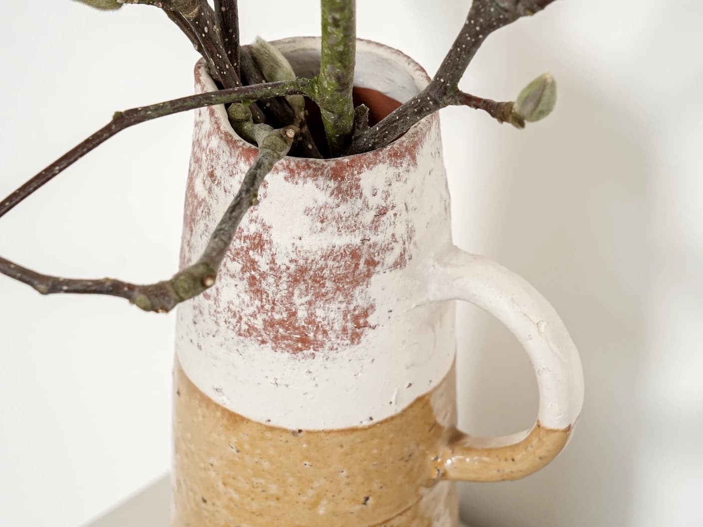 Leva Terra vases in white and beige, shown in a lifestyle close-up top view