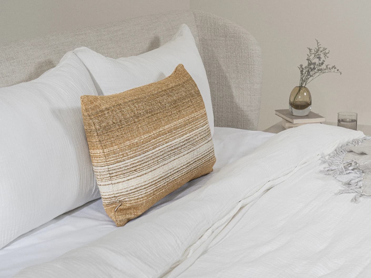 Lia Ember III single cushions in cream, shown in a lifestyle left view