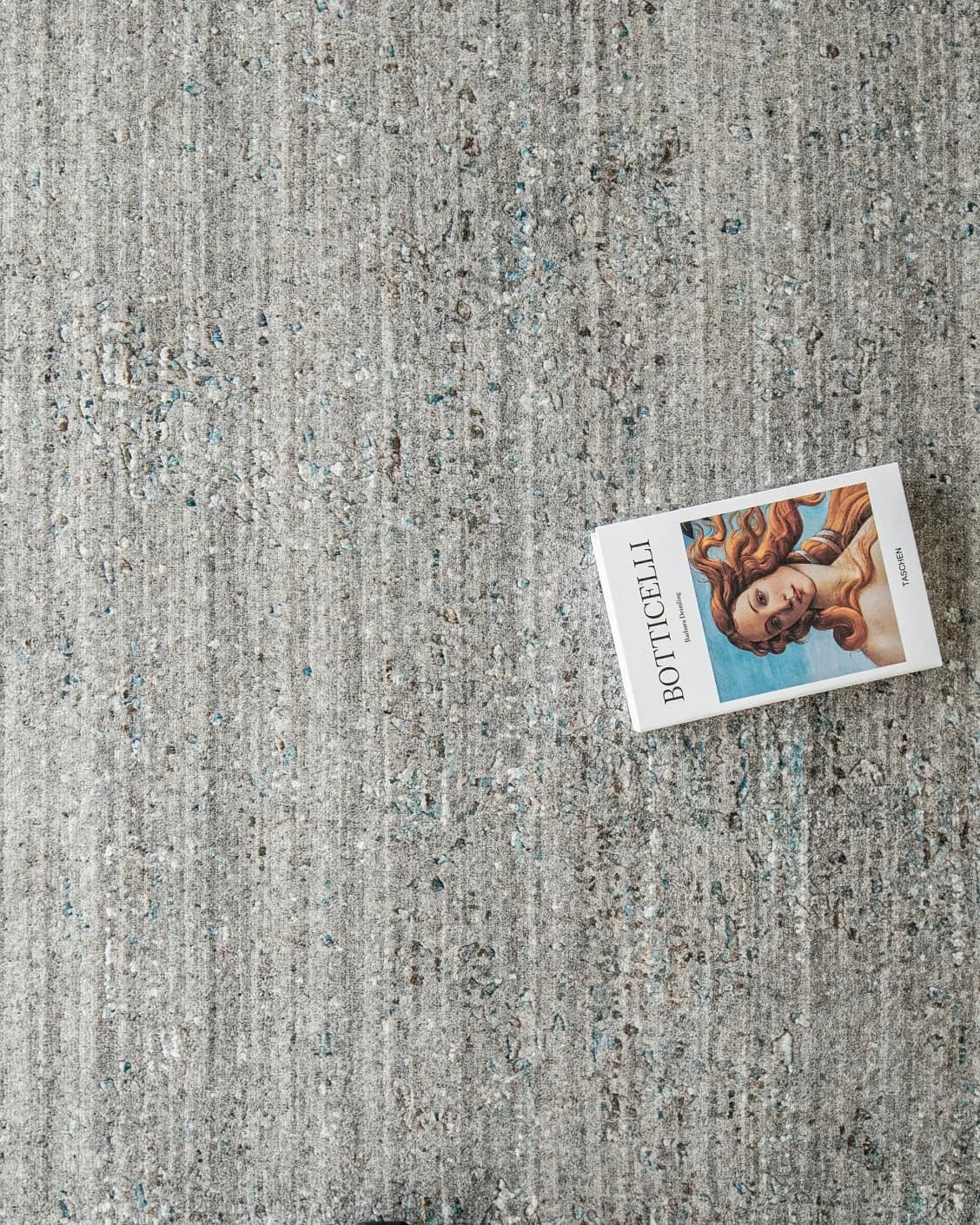 Liam Ashton carpet in grey, shown in a lifestyle top view as image 7
