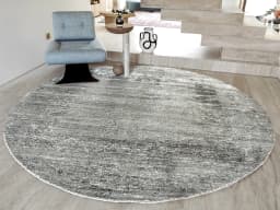 Liam Ashton Round carpet in grey, shown in a lifestyle front view