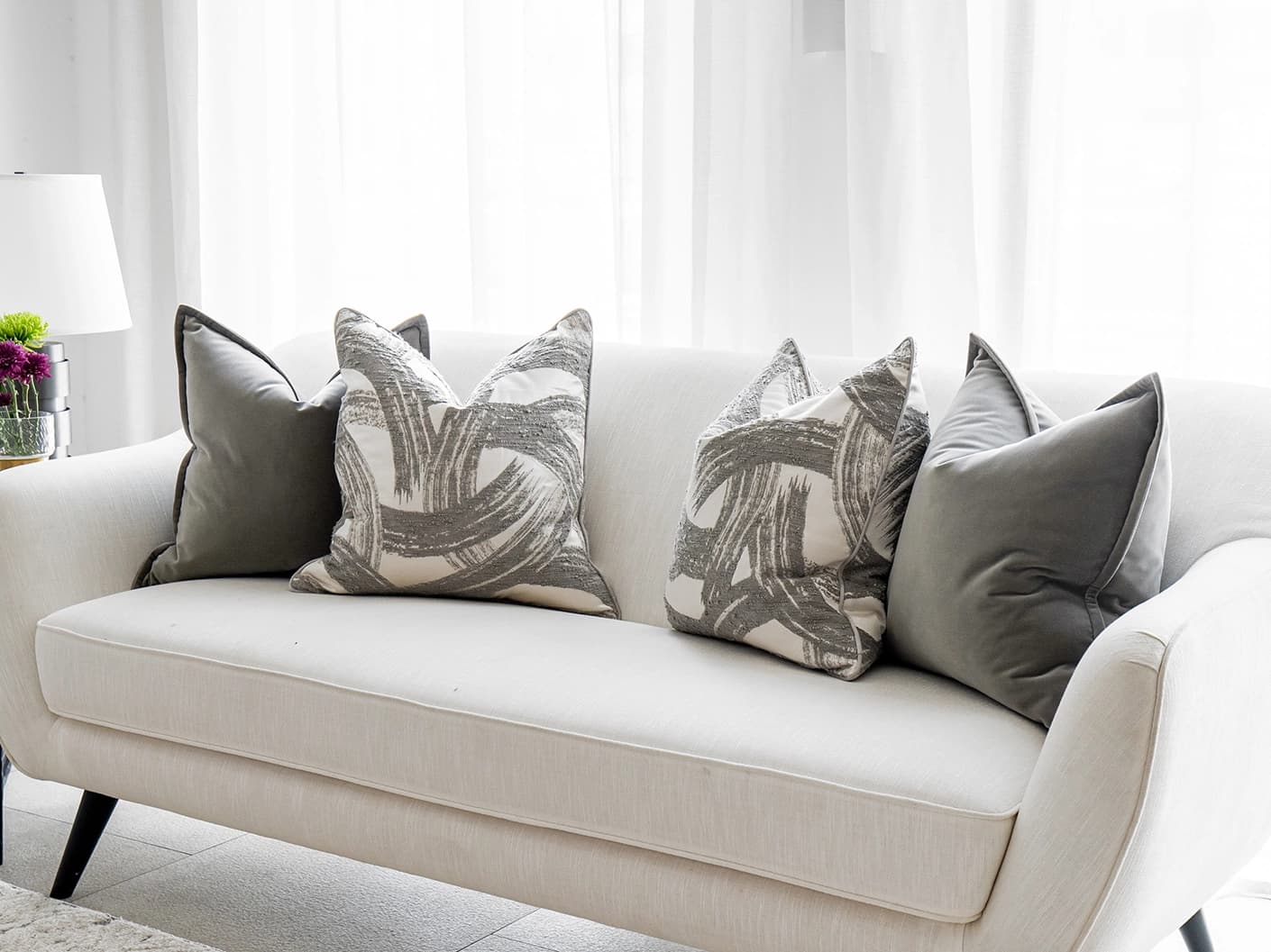 Lilian Bundle bundle cushions in grey and white, shown in a lifestyle front view