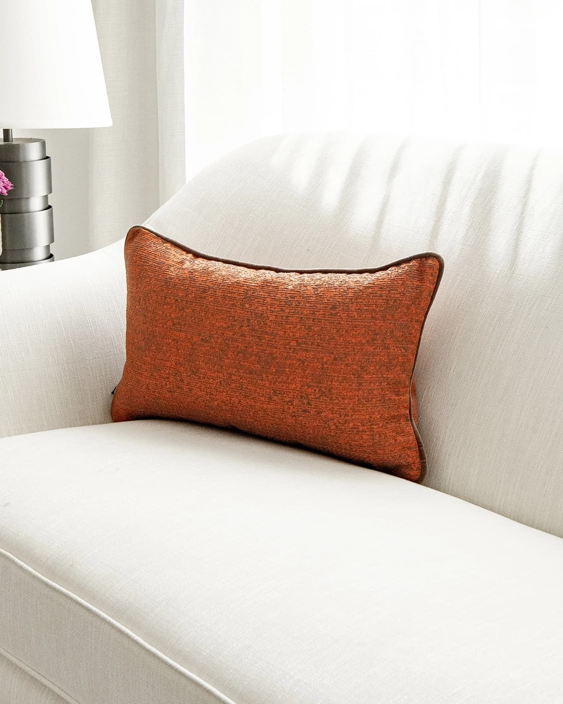 Linda Tangelo cushion in orange, shown in a lifestyle front view as image 2