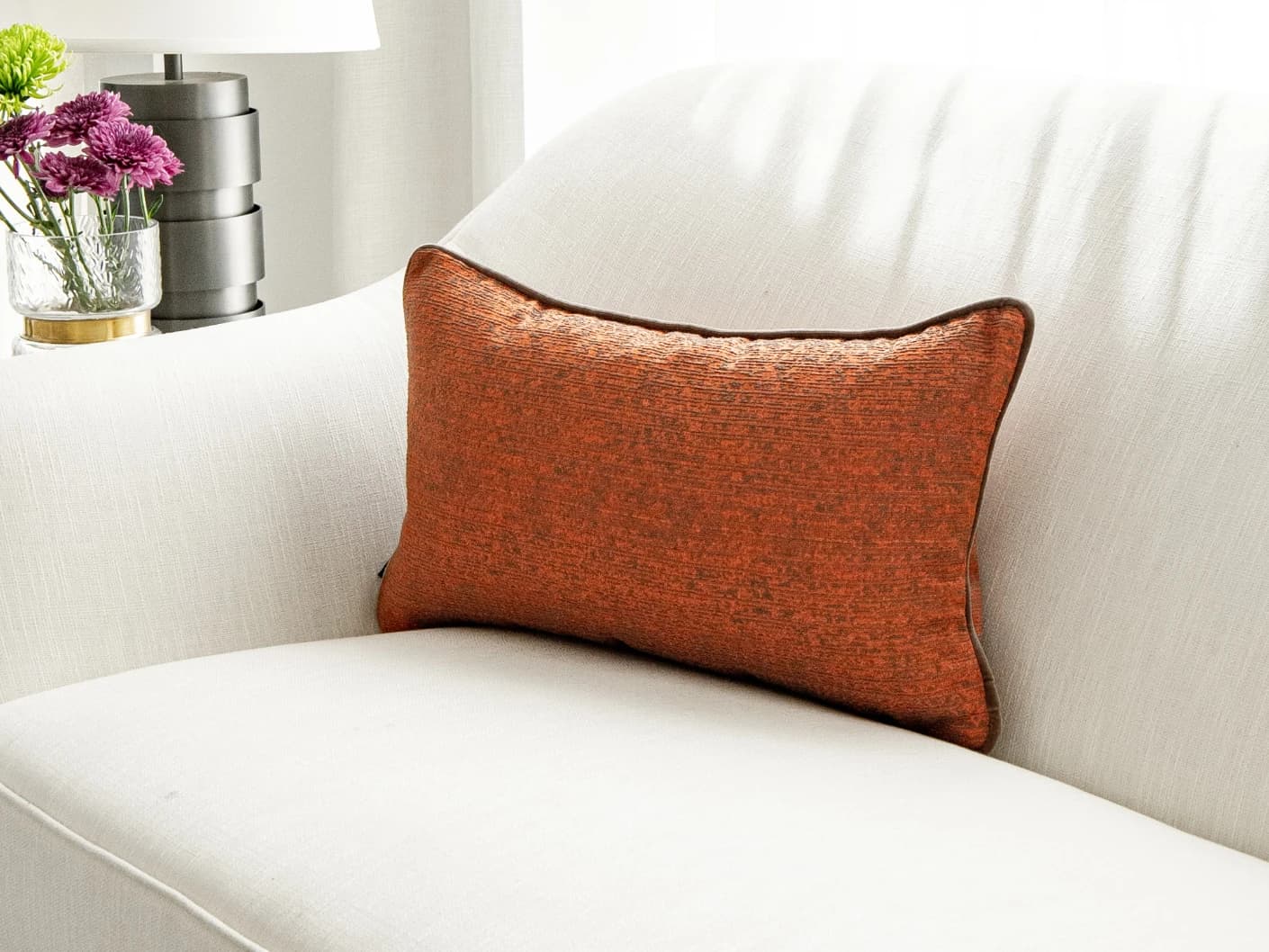 Linda Tangelo single cushions in tangelo and orange, shown in a lifestyle front view