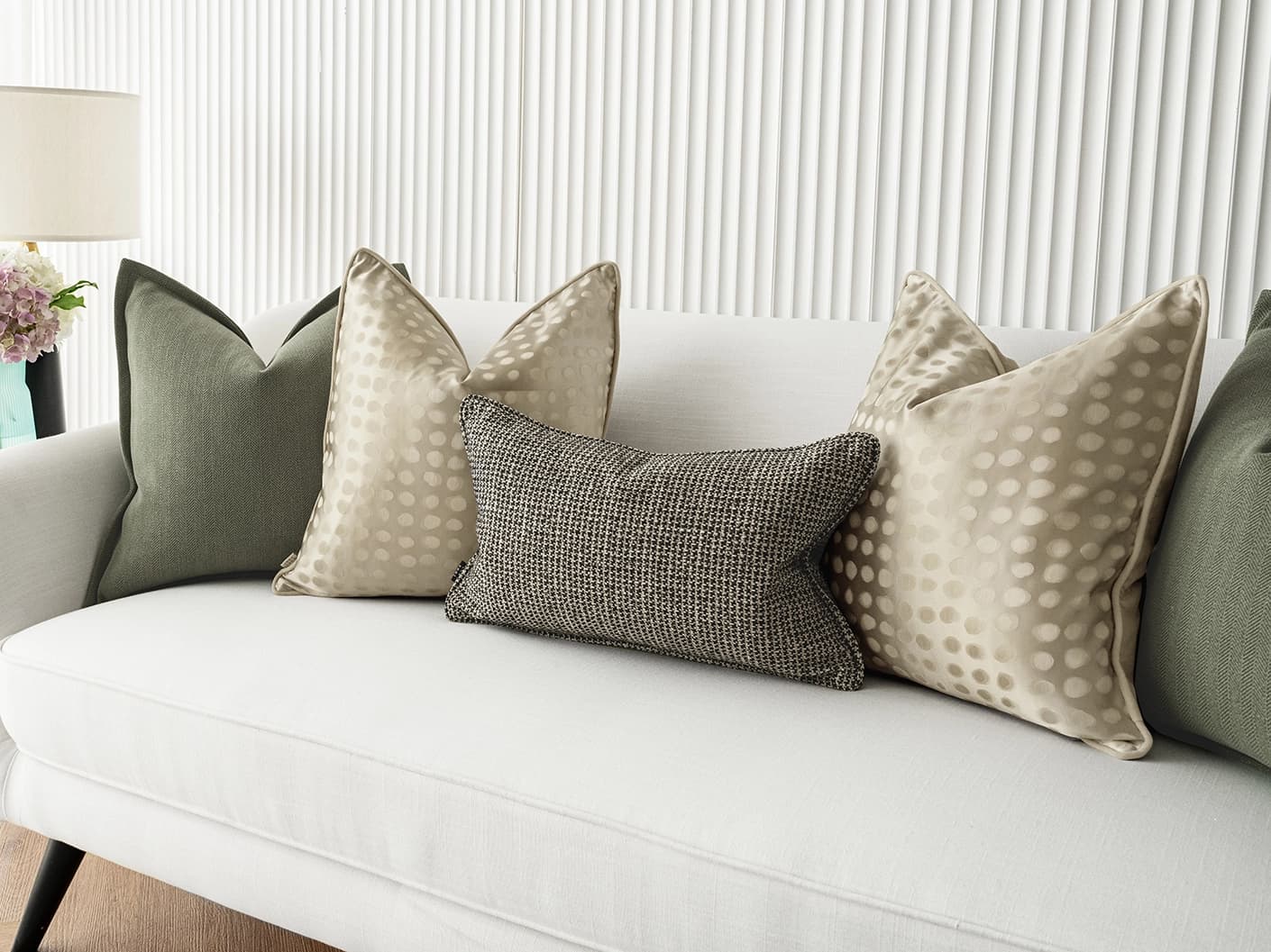Lirika Bundle bundle cushions in black, green, beige and gold, shown in a lifestyle front view