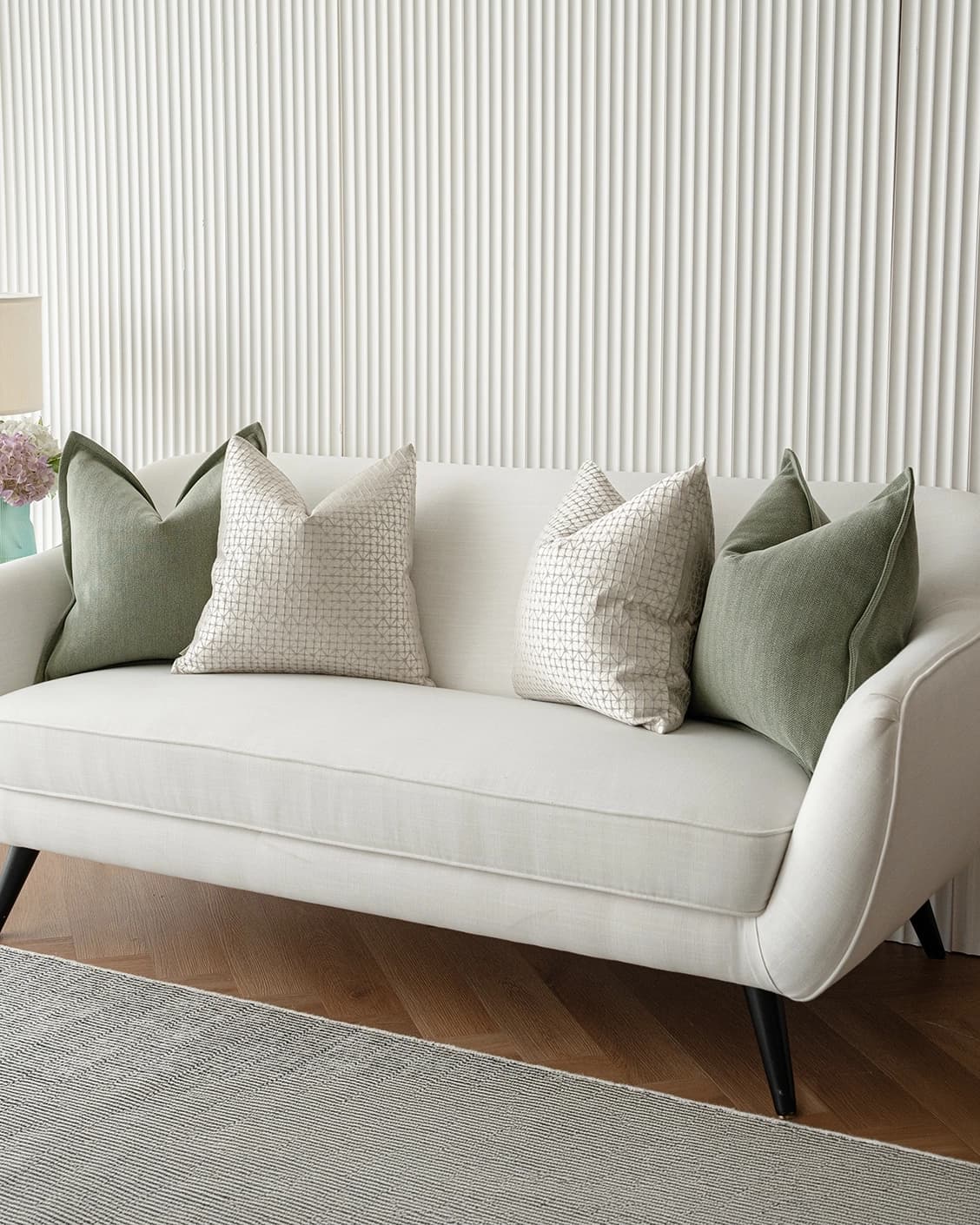 Lloyd Bundle cushion in silver, white and green, shown in a lifestyle right view as image 2