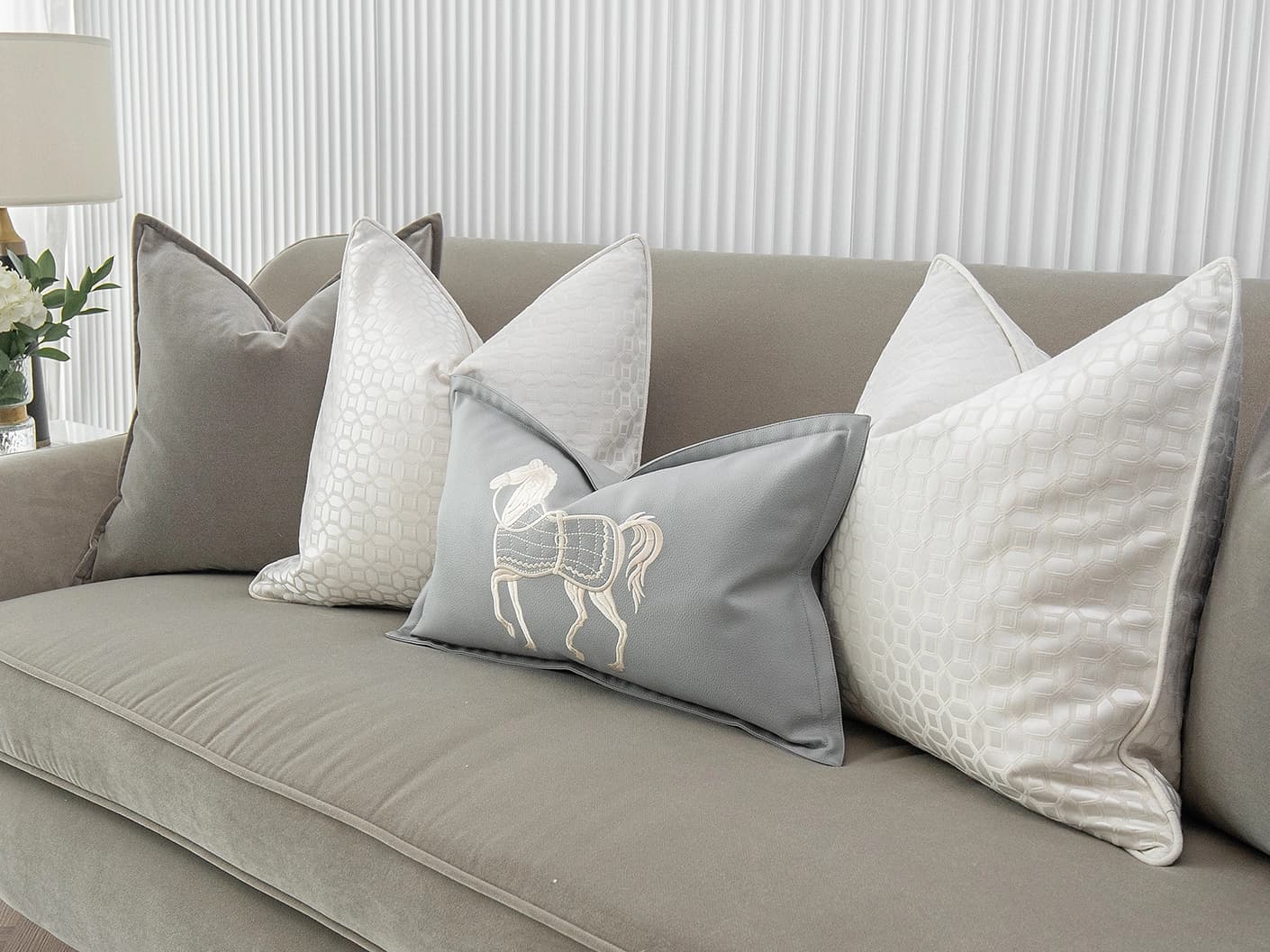 Lorenzo Bundle bundle cushions in grey, white and blue, shown in a lifestyle front view