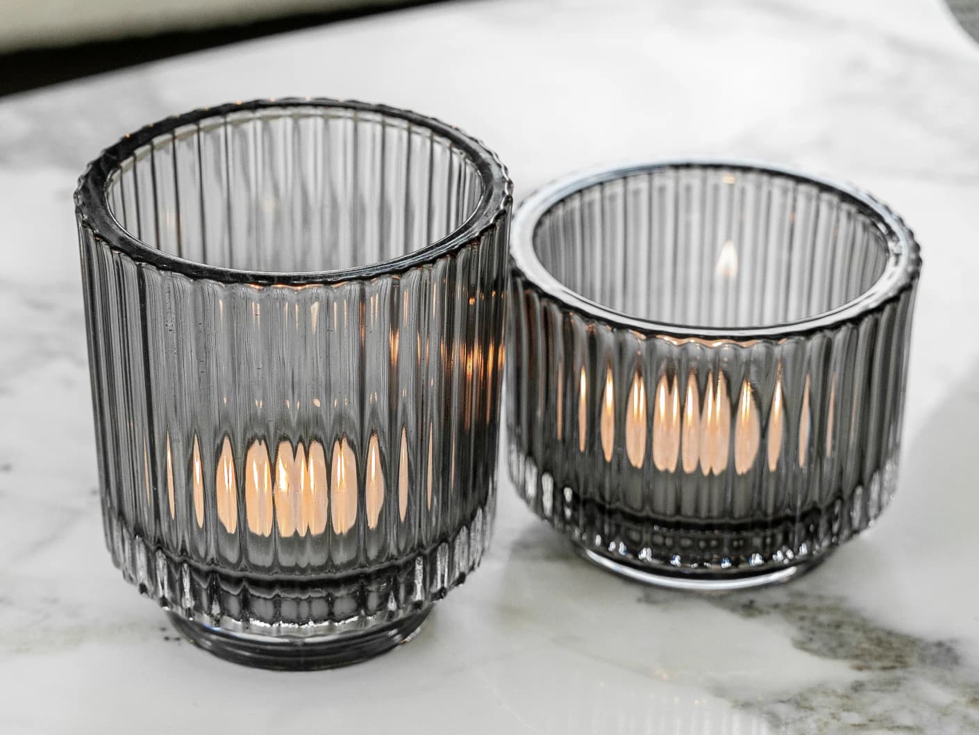 Loucille Storms candle holders in grey, shown in a lifestyle left view