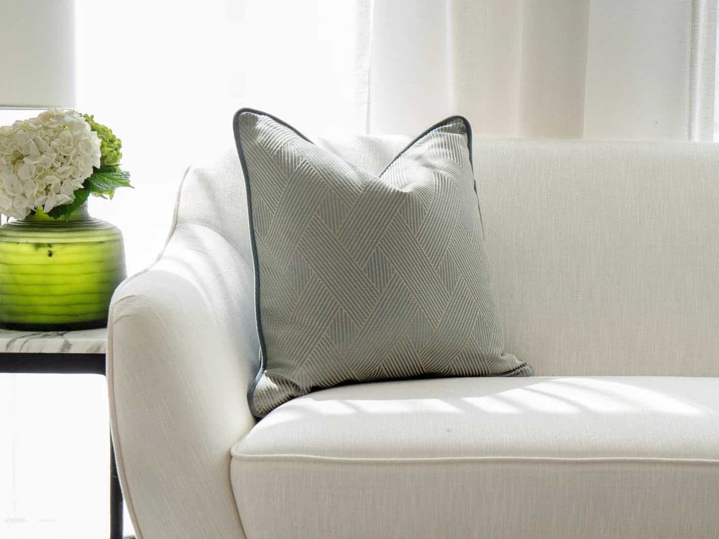 Lucas Matisse single cushions in blue, shown in a lifestyle front view
