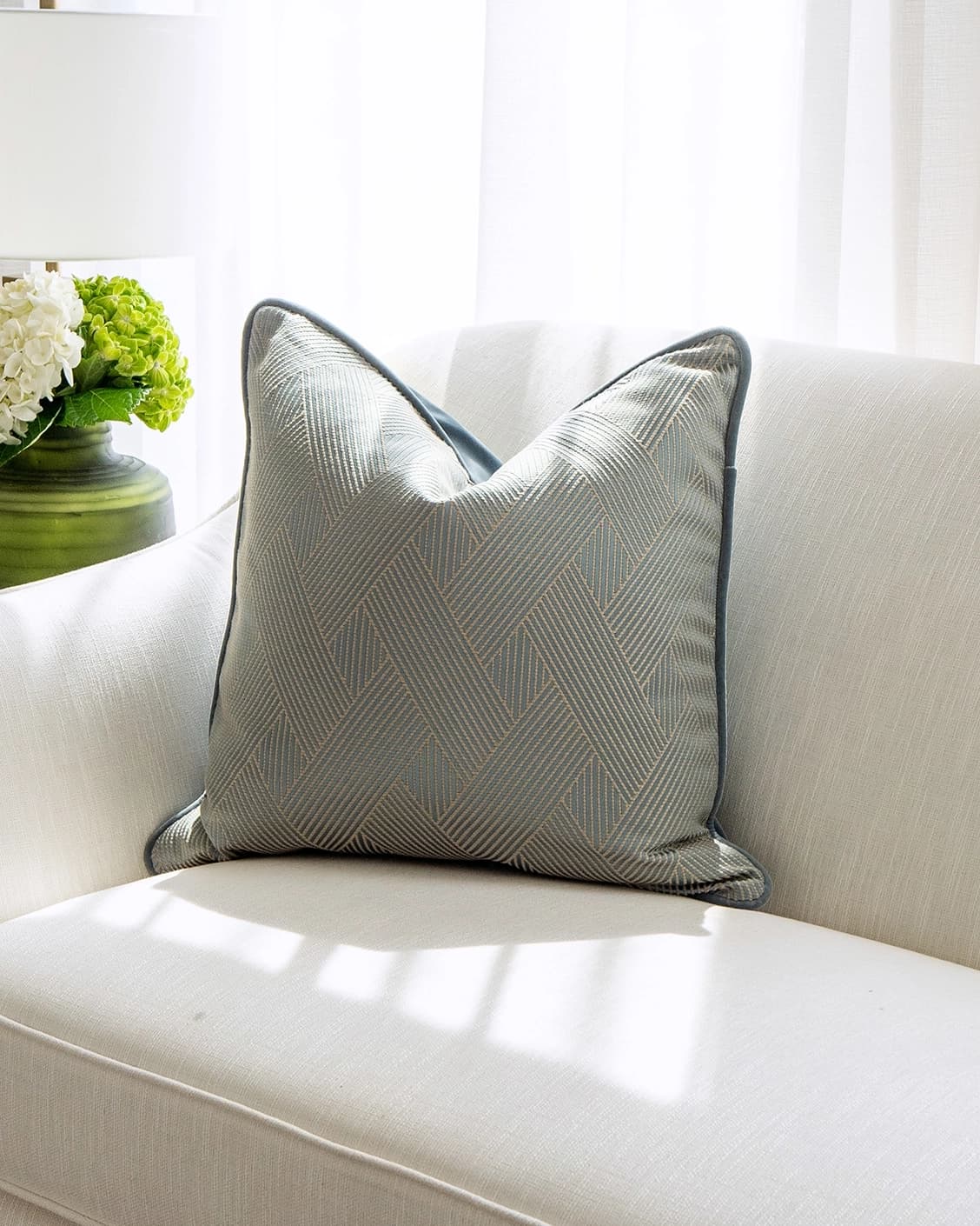 Lucas Matisse cushion in blue, shown in a lifestyle front view as image 2