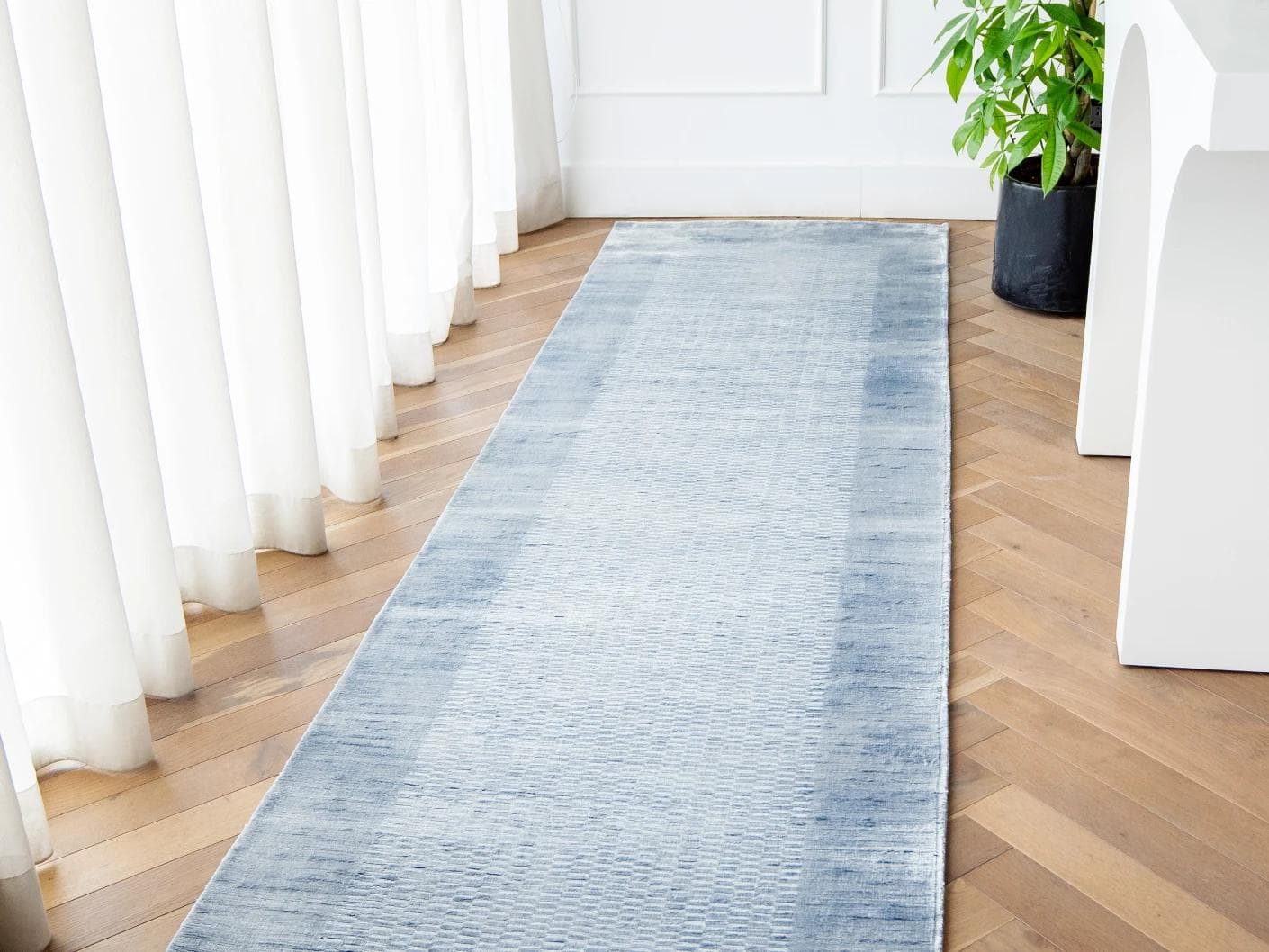 Luna Sky carpets in blue, shown in a lifestyle front view as image 1