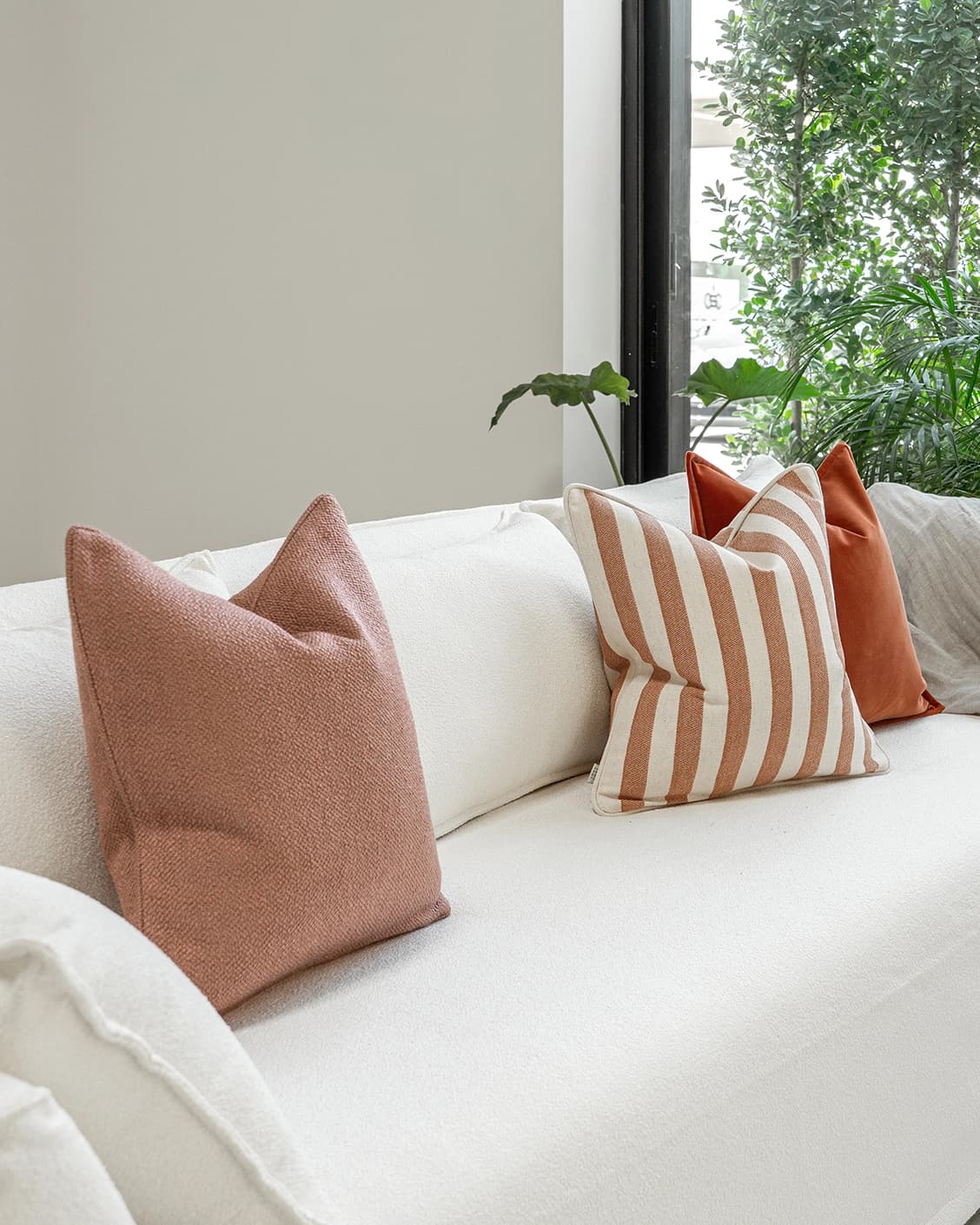 Lux Bundle cushion in rust and pink, shown in a lifestyle left view as image 2