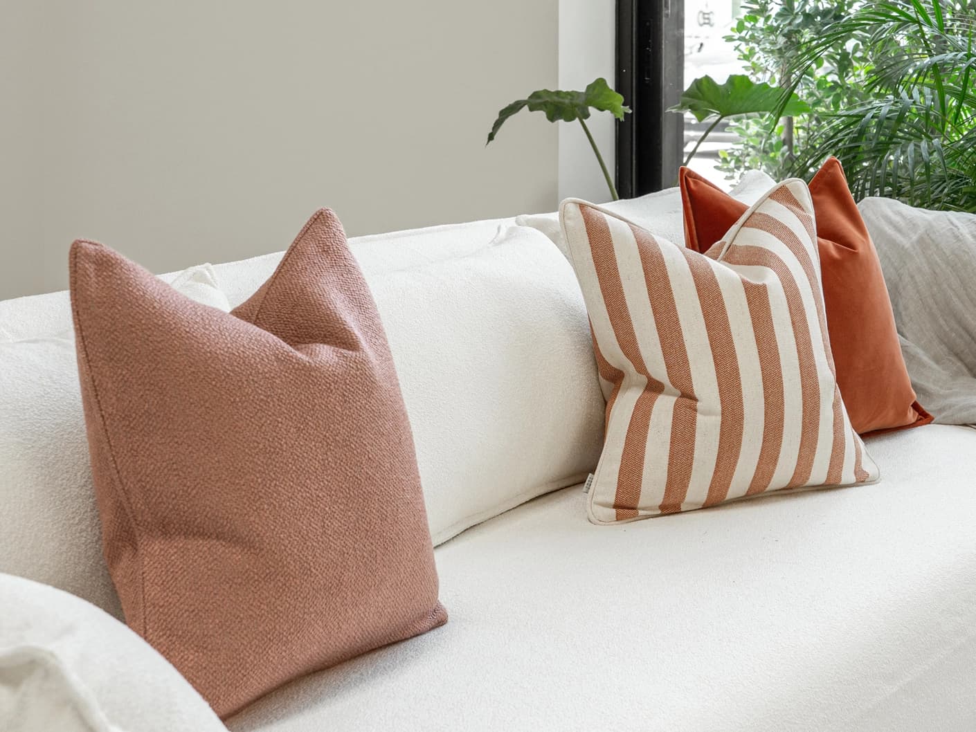Lux Bundle bundle cushions in rust and pink, shown in a lifestyle front view