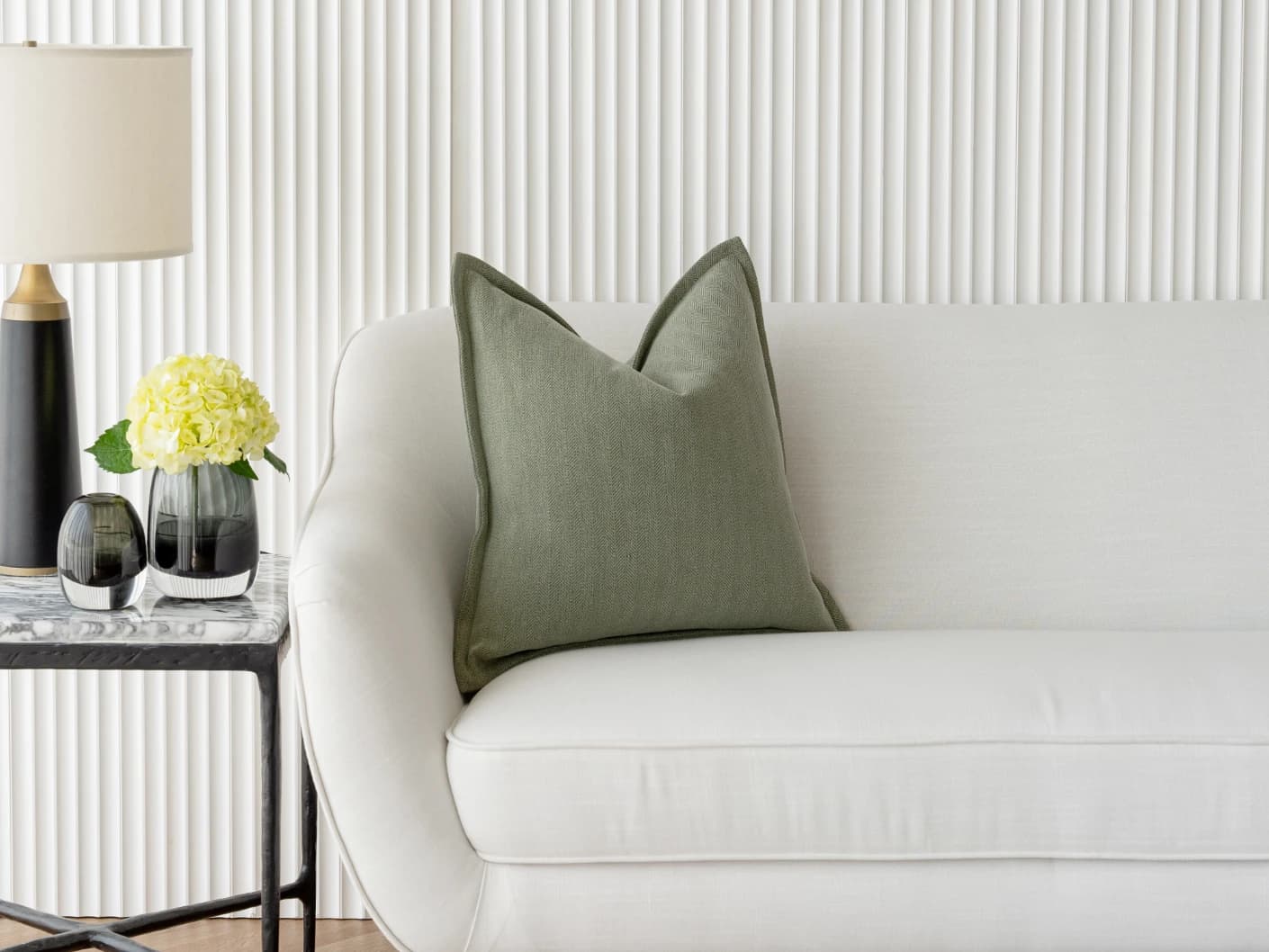 Lyndon Sage single cushions in green, shown in a lifestyle front view