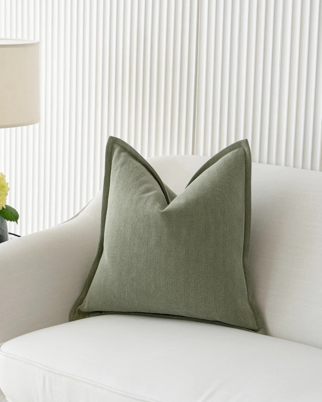 Lyndon Sage cushions in green, shown in a lifestyle front view as video image