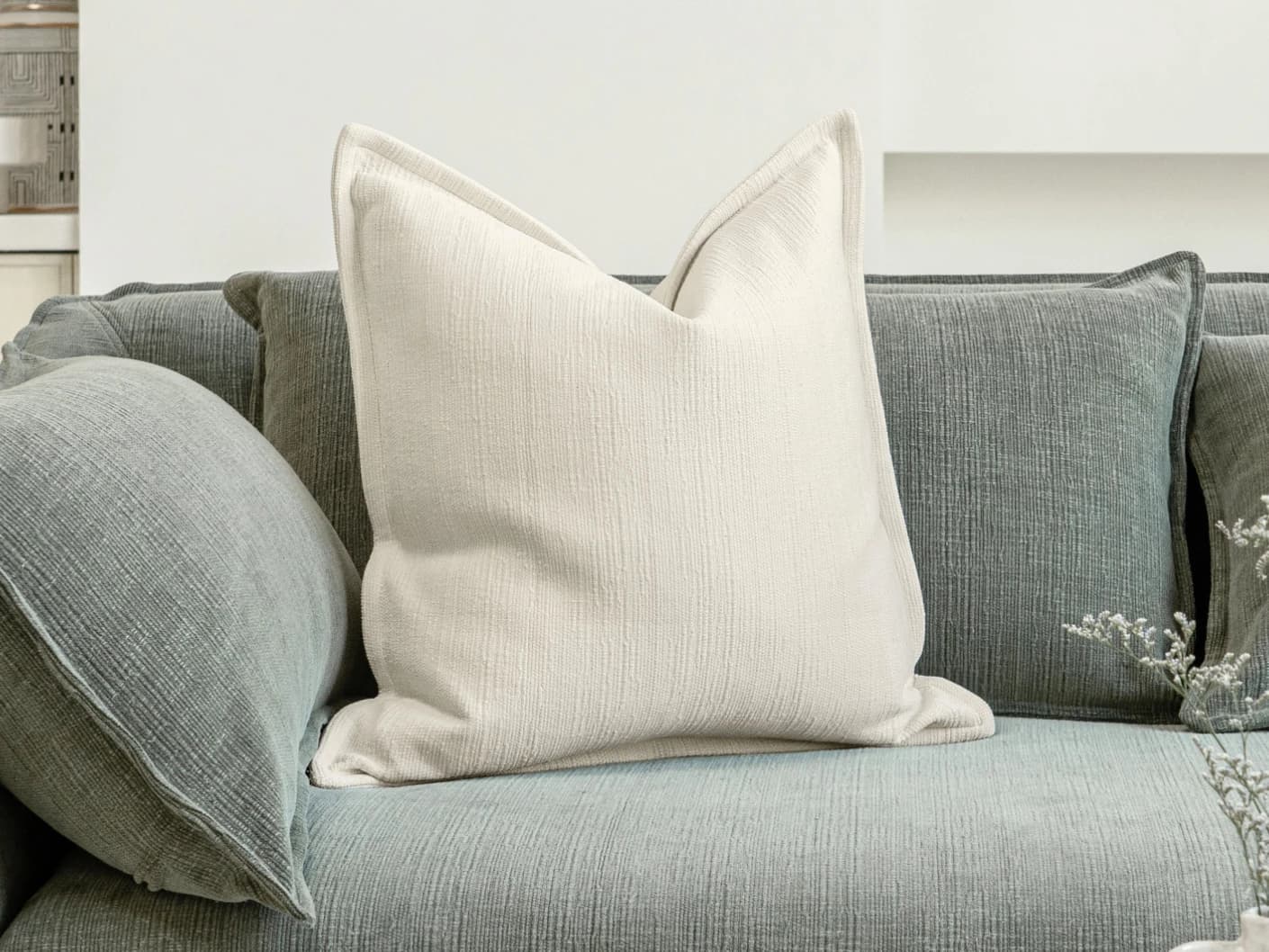 Macey Shale single cushions in ivory, shown in a lifestyle front view