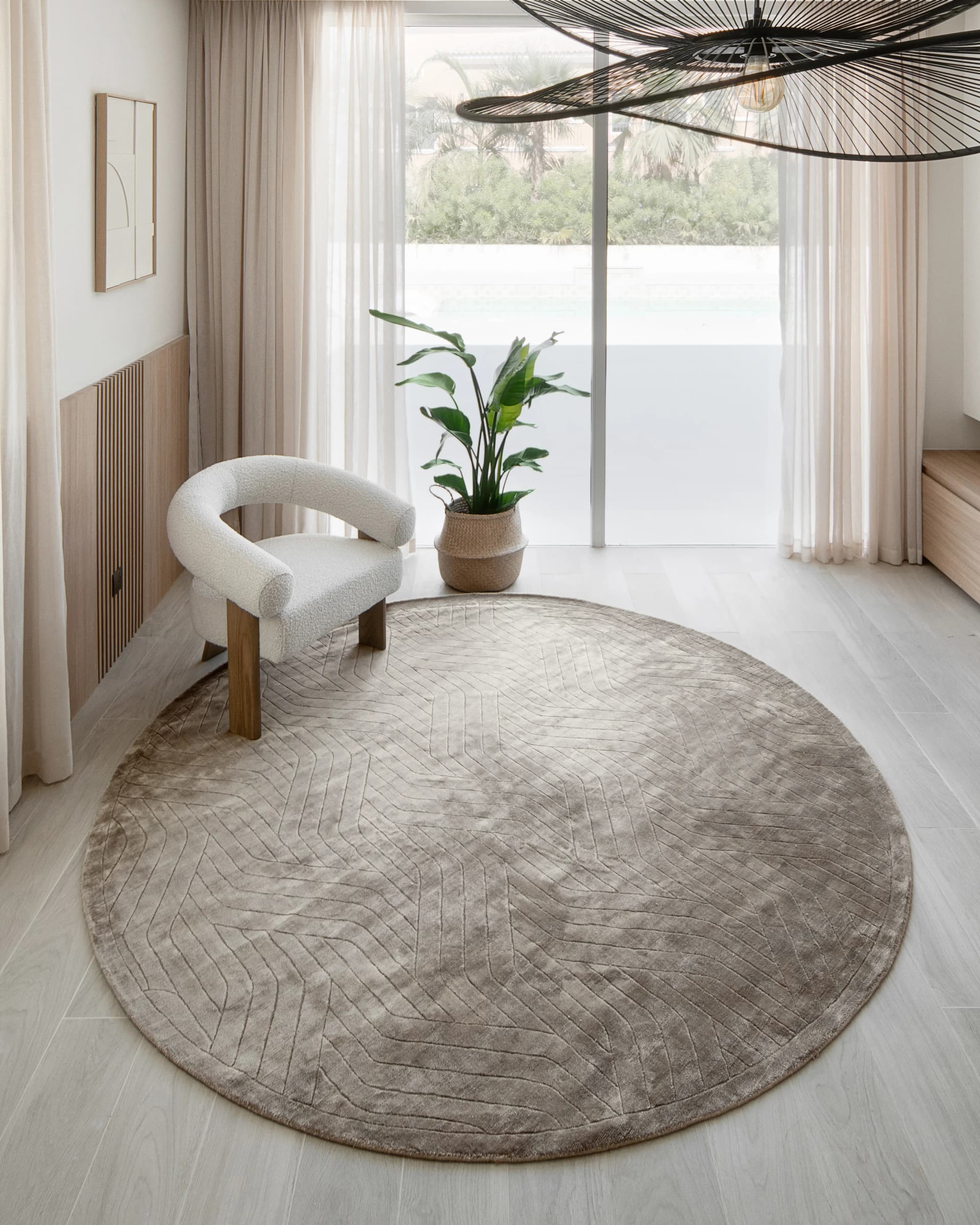 Madox Sandy Round carpet in sandy and taupe, shown in a lifestyle top view as image 2