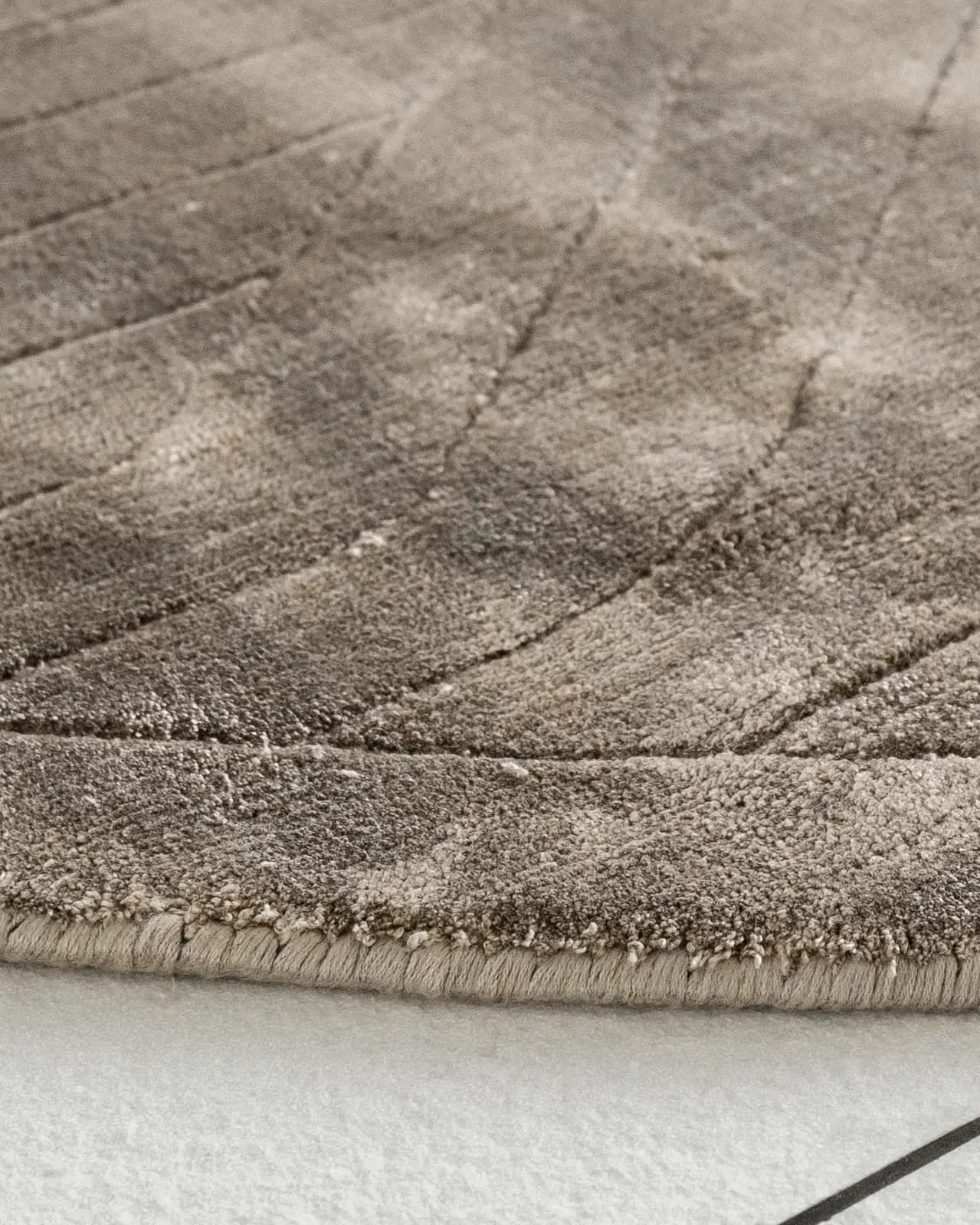 Madox Sandy Round carpet in sandy and taupe, shown in a lifestyle close-up as image video image