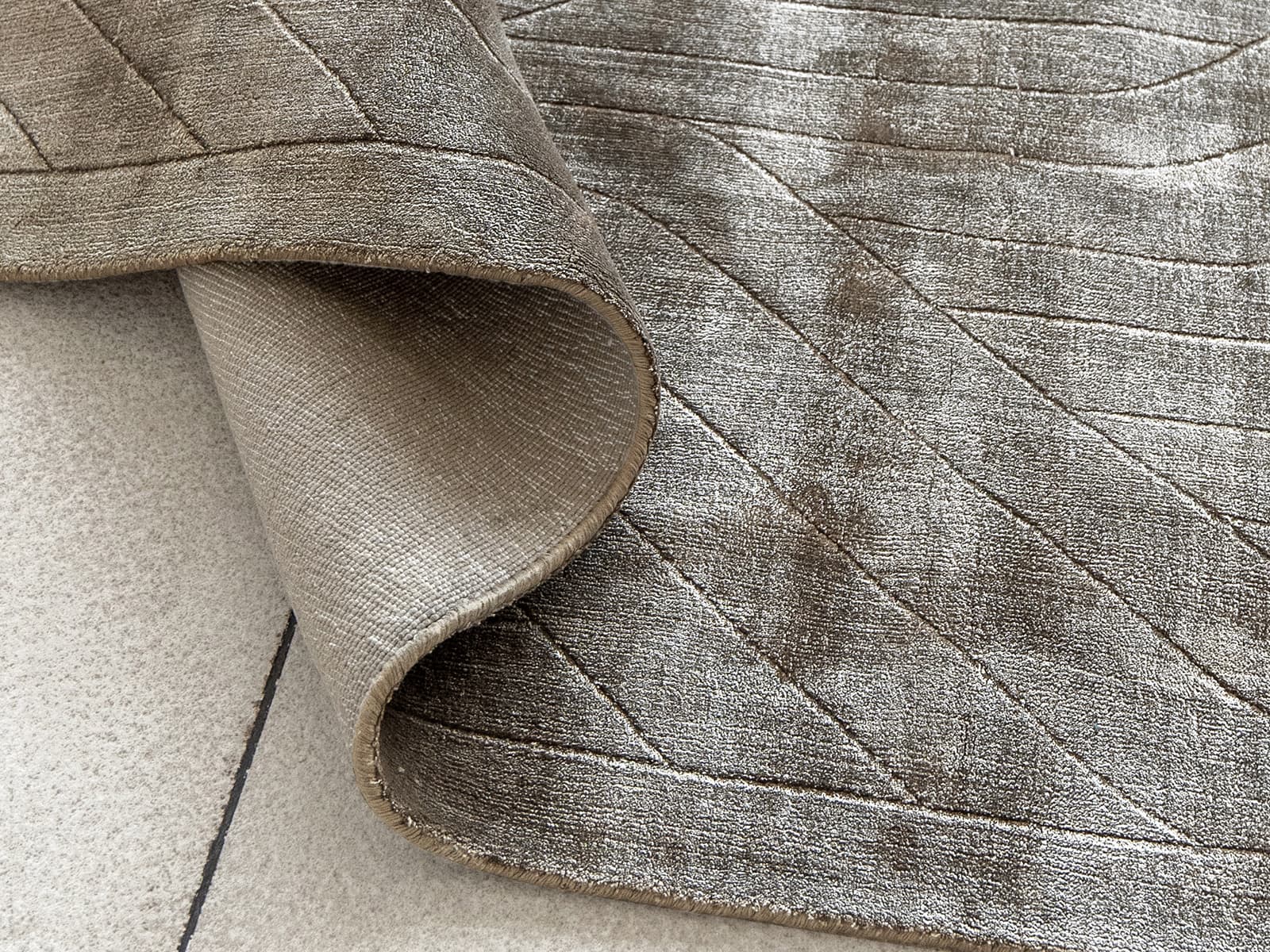 Madox Sandy Round carpets in sandy and taupe, shown in a lifestyle top view